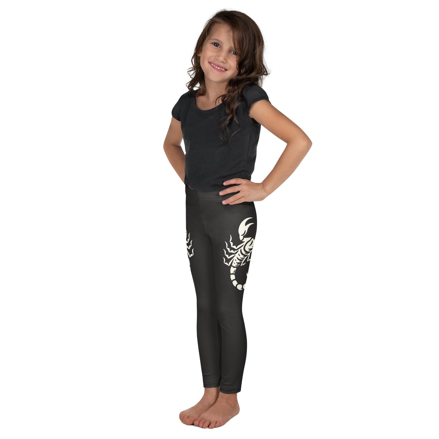 Young girl wearing dark leggings with large printed scorpion on each side