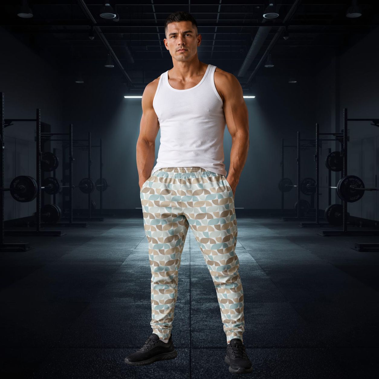 Man wearing a white tank top and pastel geometric patterned pants in a gym setting