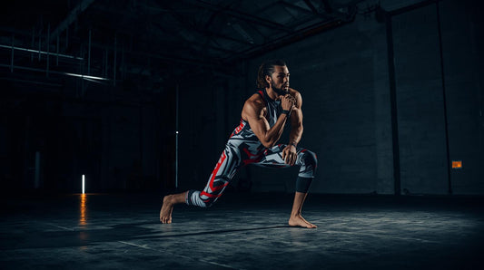 Male athlete posing in lunge position in pro wrestling compression tights