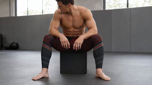 Man wearing red and black bjj spats