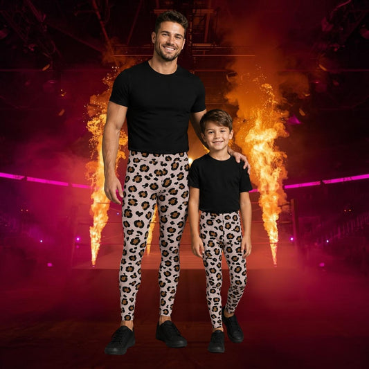 A man and a child standing together in a dark stage-like environment with dramatic orange flame effects and pink lighting. Both are wearing matching black short-sleeve t-shirts and leopard-print leggings.