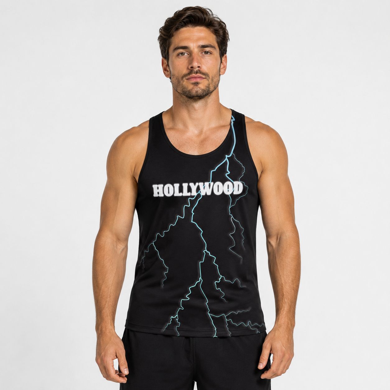 Man wearing a black tank top with 'Hollywood' with a blue lightning strike printed on it against a white background