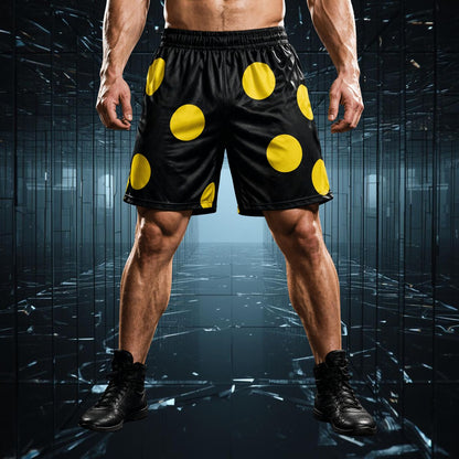 Person wearing black shorts with large yellow polka dots on a dark reflective surface