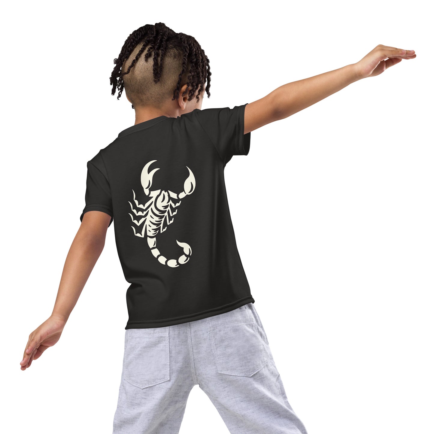 Young boy wearing dark t-shirt with large printed scorpion on the back