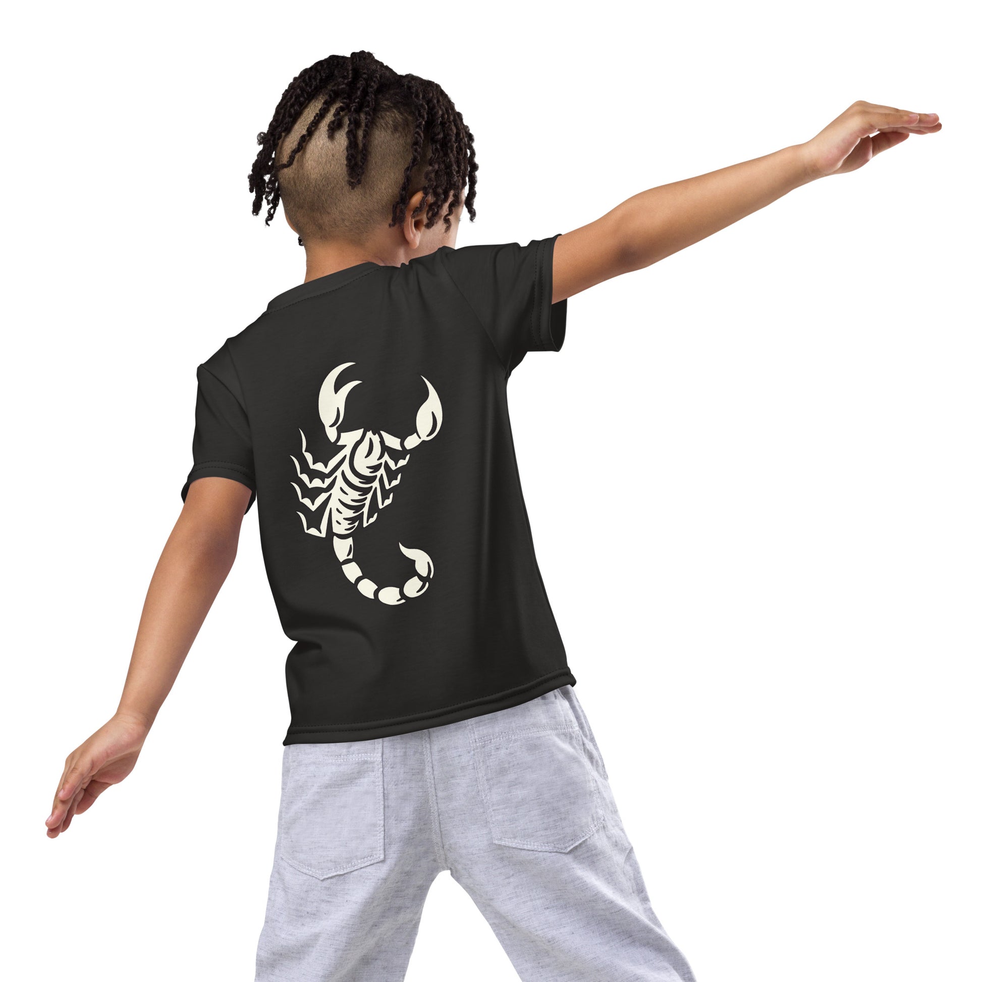 Young boy wearing dark t-shirt with large printed scorpion on the back