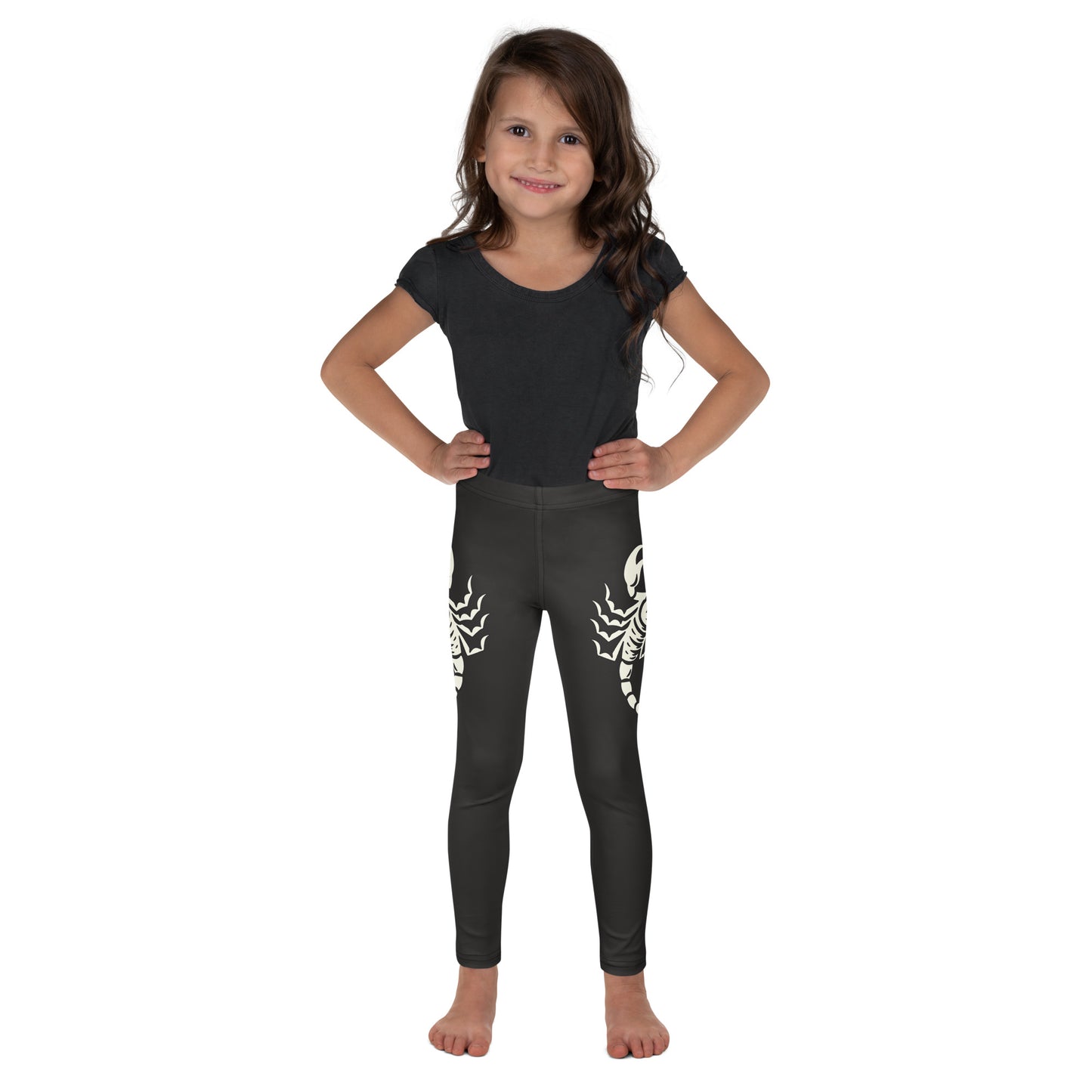 Young girl wearing dark leggings with large printed scorpion on each side