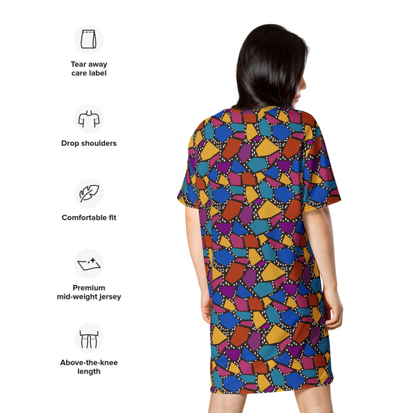 Striking geometric patterned t-shirt dress in a vibrant futuristic Synthwave colour palette against a black and white dotted background. Available here in a muted rainbow style.