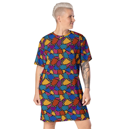 Striking geometric patterned t-shirt dress in a vibrant futuristic Synthwave colour palette against a black and white dotted background. Available here in a muted rainbow style.