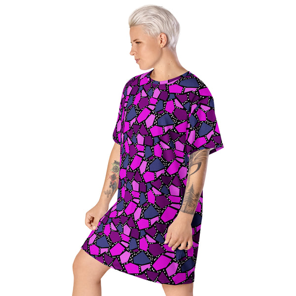  geometric patterned t-shirt dress in a vibrant futuristic Synthwave colour palette against a black and white dotted background. Available here in a metallic purple style.