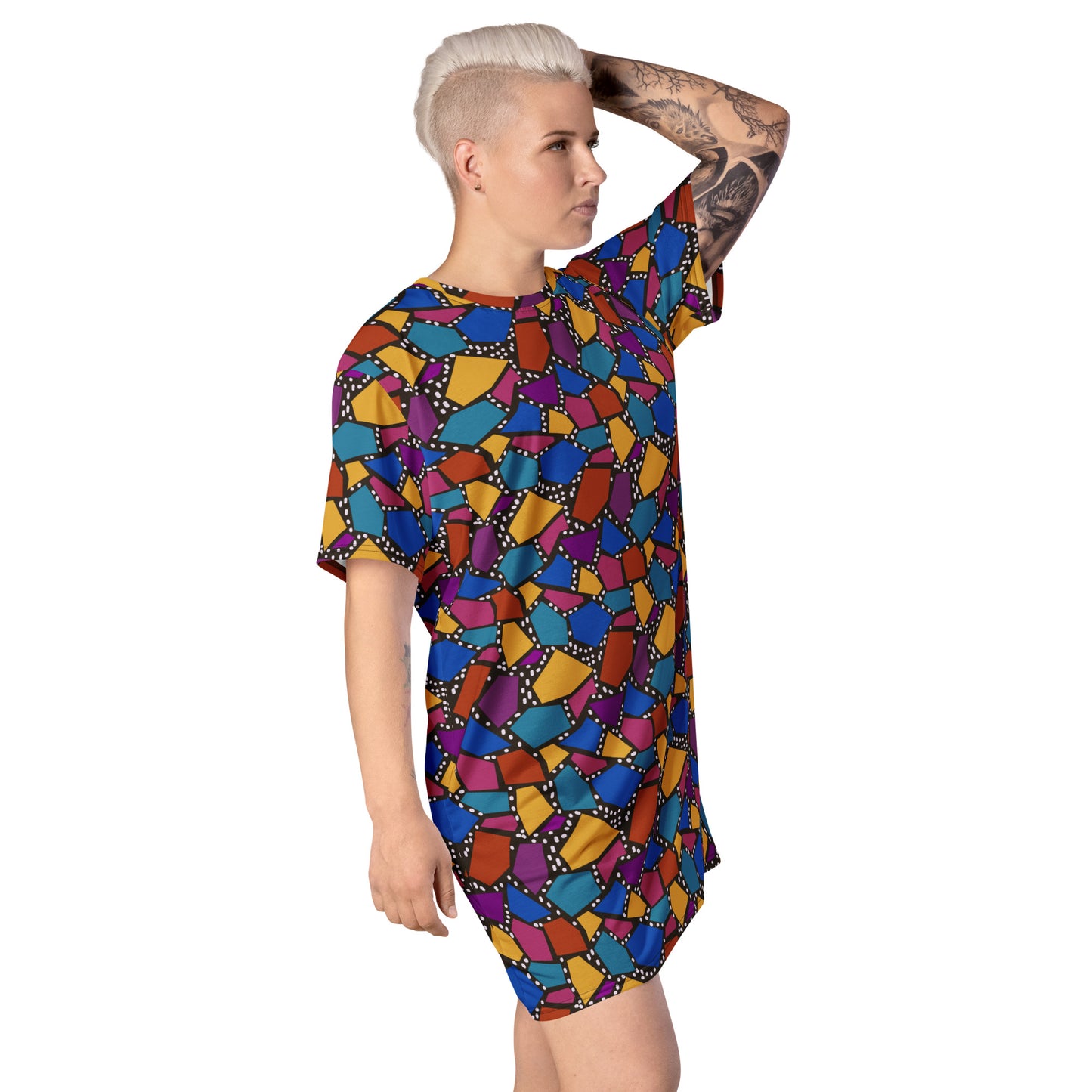 Striking geometric patterned t-shirt dress in a vibrant futuristic Synthwave colour palette against a black and white dotted background. Available here in a muted rainbow style.