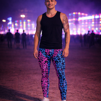 Man wearing black tank top and colorful bold festival leggings with a vibrant, blurred background of festival lights.