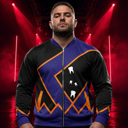 A man wearing a custom zip-up bomber jacket with a black and purple design, orange geometric accents, and white tooth graphics, set against a dark stage background with red spotlights.