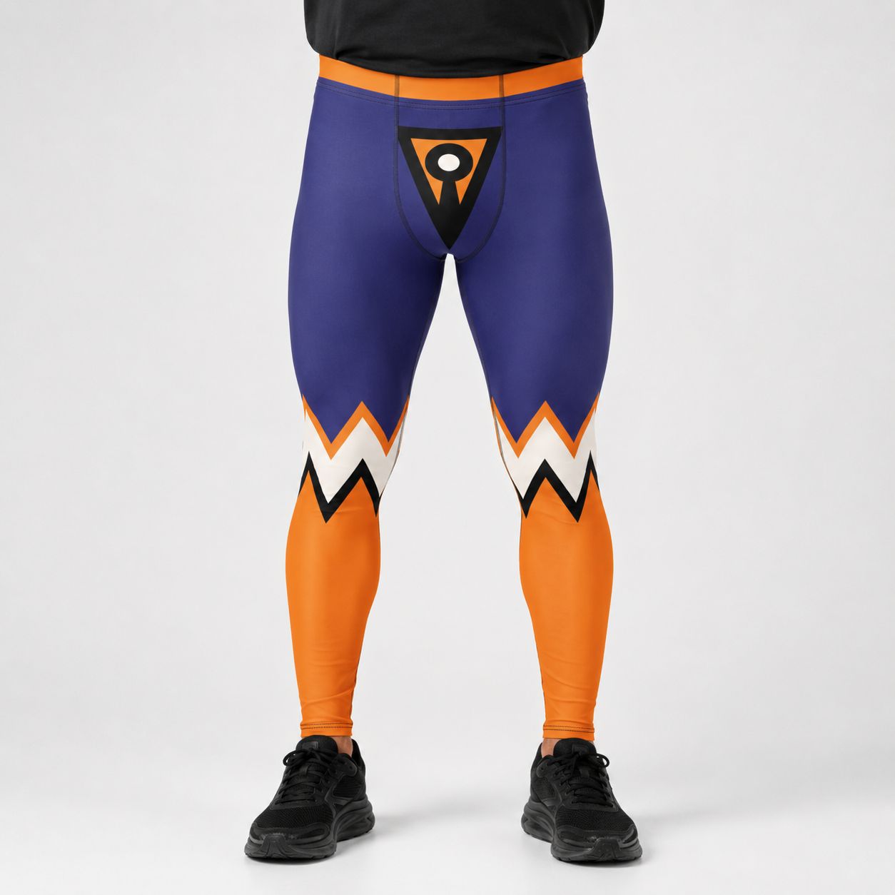 A person wearing full-length athletic leggings with a purple upper portion, orange lower portion, and white and black zigzag accents near the knees, shown against a light gray studio background.