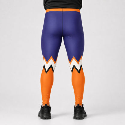 A person viewed from the back wearing high-waisted athletic leggings with a bold color-blocked design: purple upper legs, bright orange lower legs, and a zigzag pattern in white, black, and orange near the knees. The person is also wearing a black top and black sneakers against a light gray studio background.