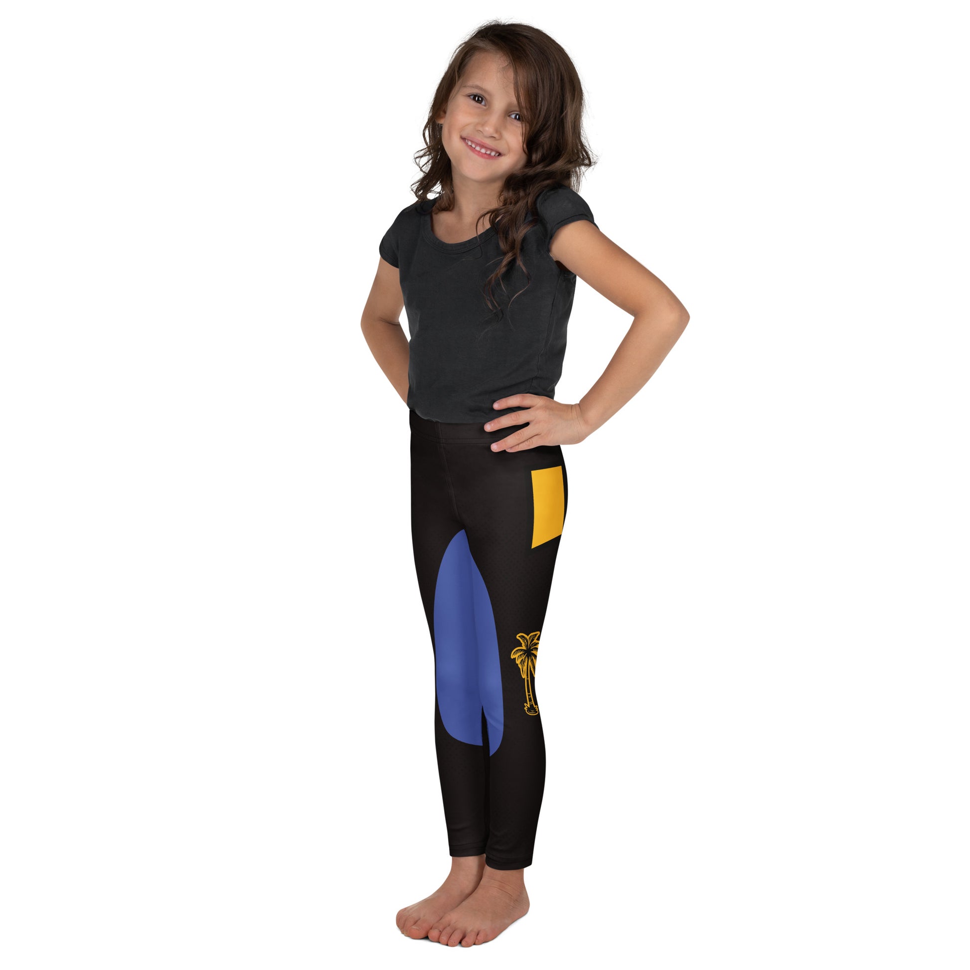 Girl wearing black and gold wrestling-inspired leggings with blue knee panels