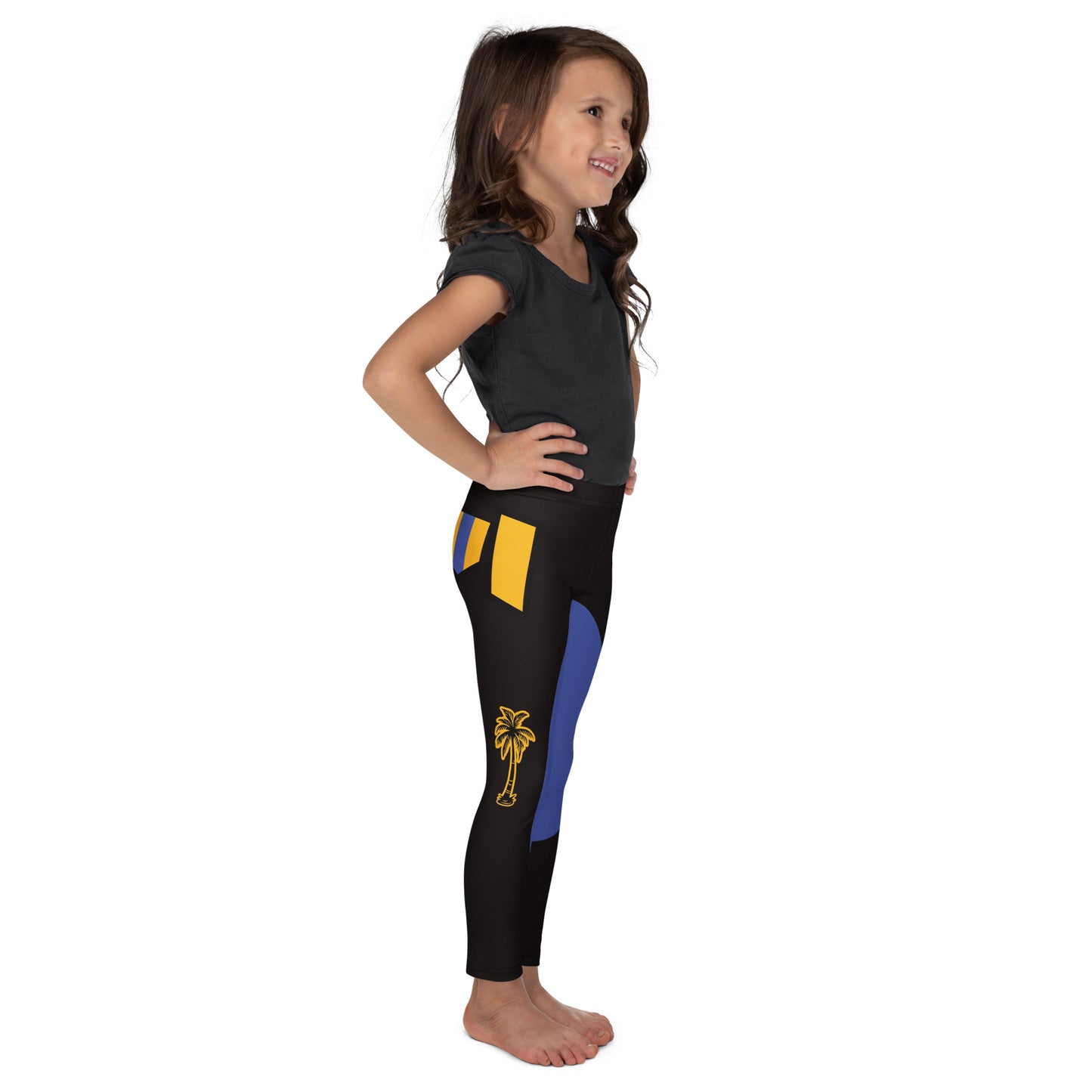 Child wearing black and gold wrestling-inspired leggings with blue knee panels, facing right