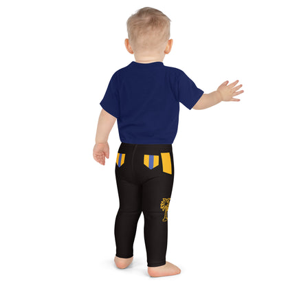 Child wearing black and gold wrestling-inspired leggings with blue knee panels, back view