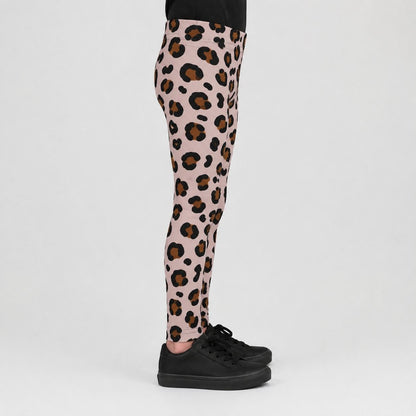 Pink leopard print leggings worn by a model, paired with black sneakers, shown from the waist down against a light gray studio background.