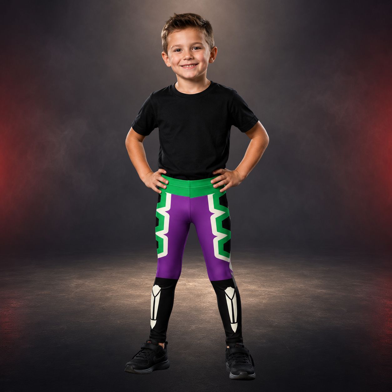 Child wearing a black t-shirt and colorful purple and green luchador wrestling pants on a dark background