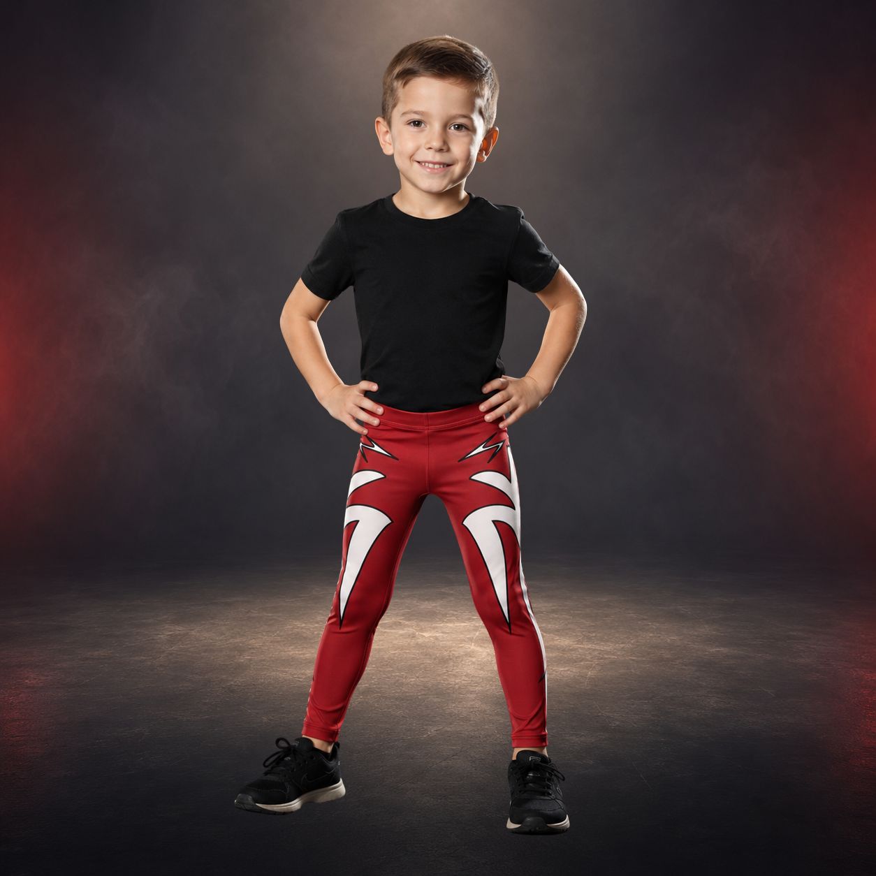 Child wearing a black t-shirt and red pants with white lightning design on a dark background