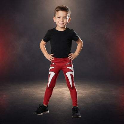 Child wearing a black t-shirt and red pants with white lightning design on a dark background