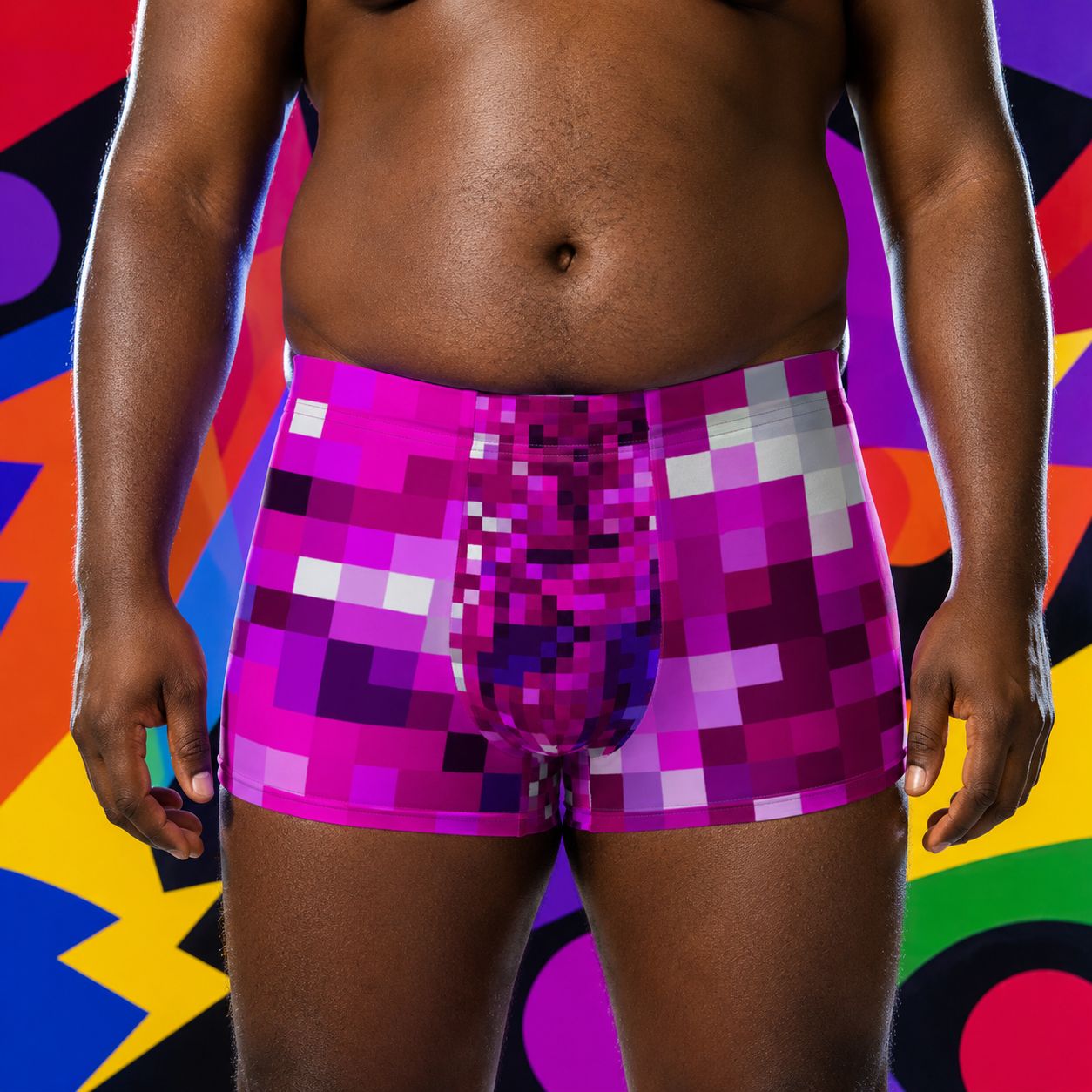 Person wearing colorful pixelated purple boxer briefs against a multicolored abstract background