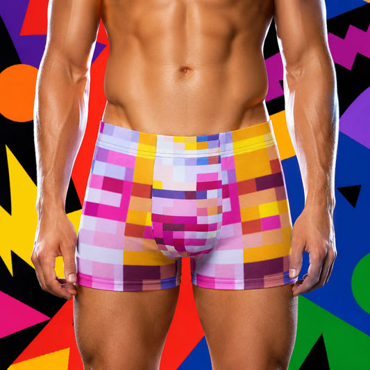 Multicolored rainbow patterned boxer briefs on a person against a colorful geometric background