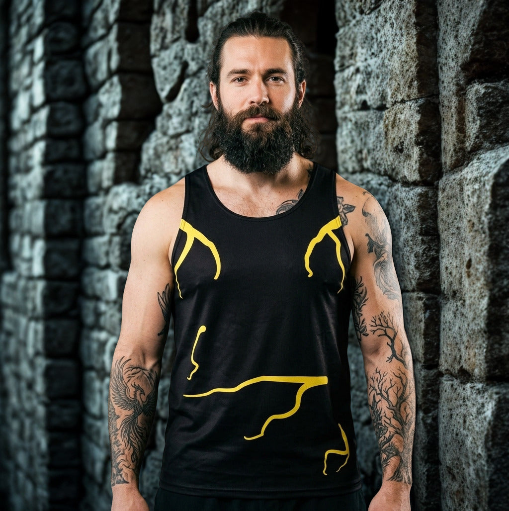 Man wearing a black tank top  with molten yellow designs against a gothic stone wall in spooky image