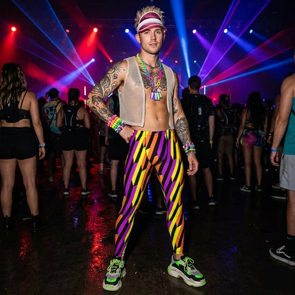 Person in colorful outfit with striped fashion leggings and tattoos at a concert with vibrant lights.