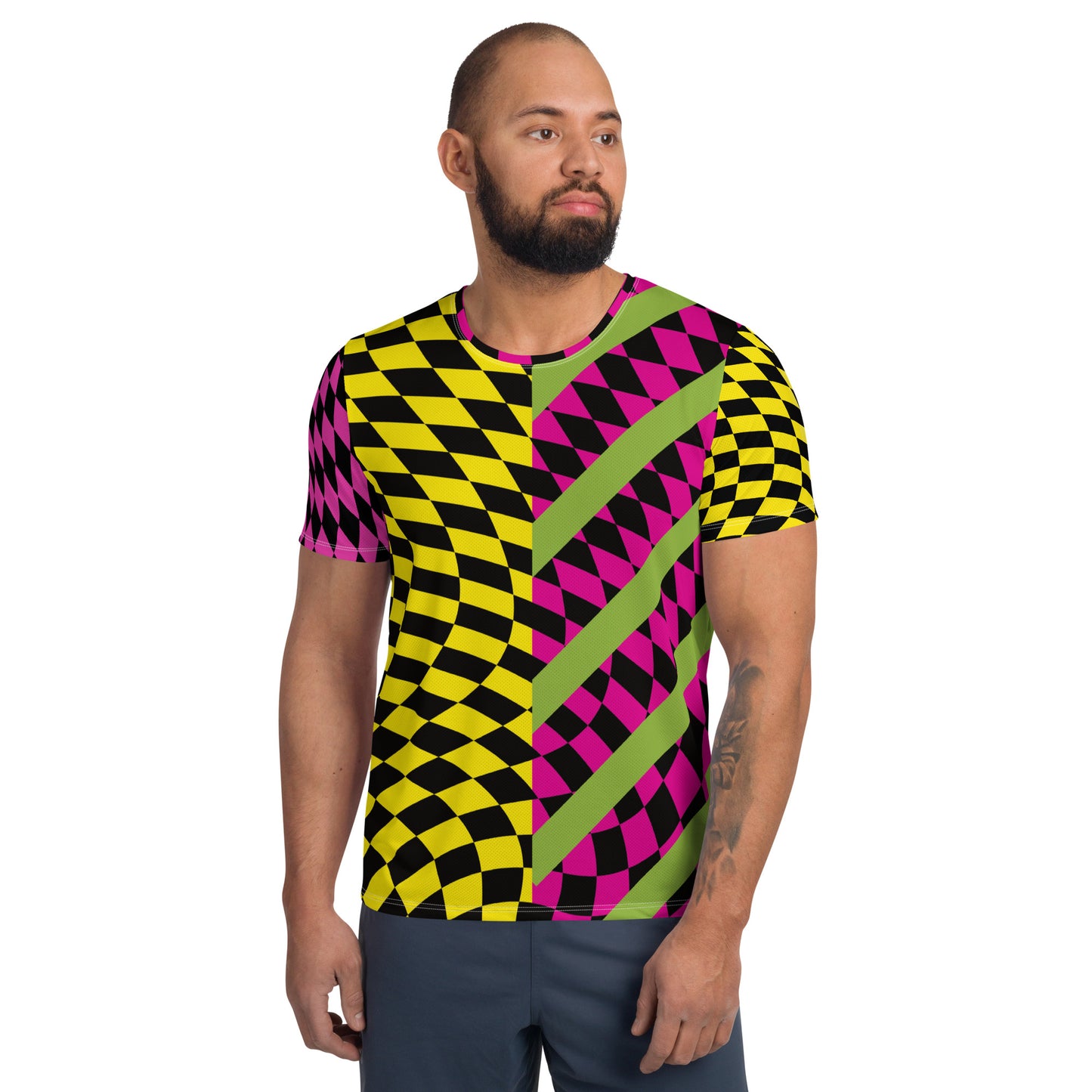 A man wearing a retro colorful geometric patterned athletic t-shirt with black checked design.