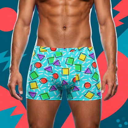 Person wearing colorful geometric patterned boxer briefs against a vibrant abstract background