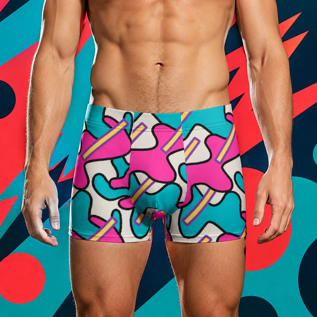 Person wearing colorful boxer briefs with a geometric Memphis style pattern on a multicolored abstract background