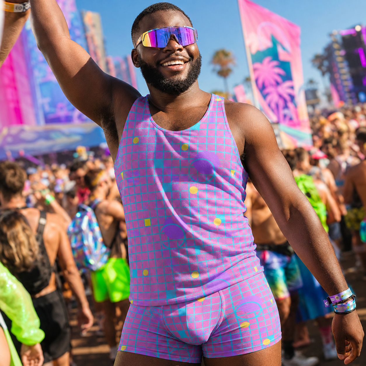 Man in a colorful futuristic outfit and sunglasses at a music festival