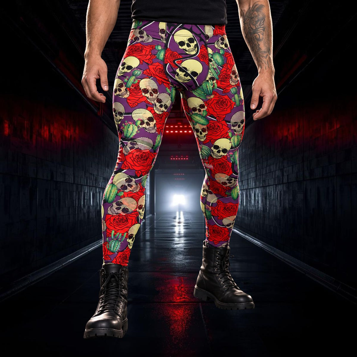 A person wearing high-waisted leggings with a vivid skull-and-rose print in red, purple, green, black, and cream, paired with black combat boots, standing in a dark tunnel with red lighting.