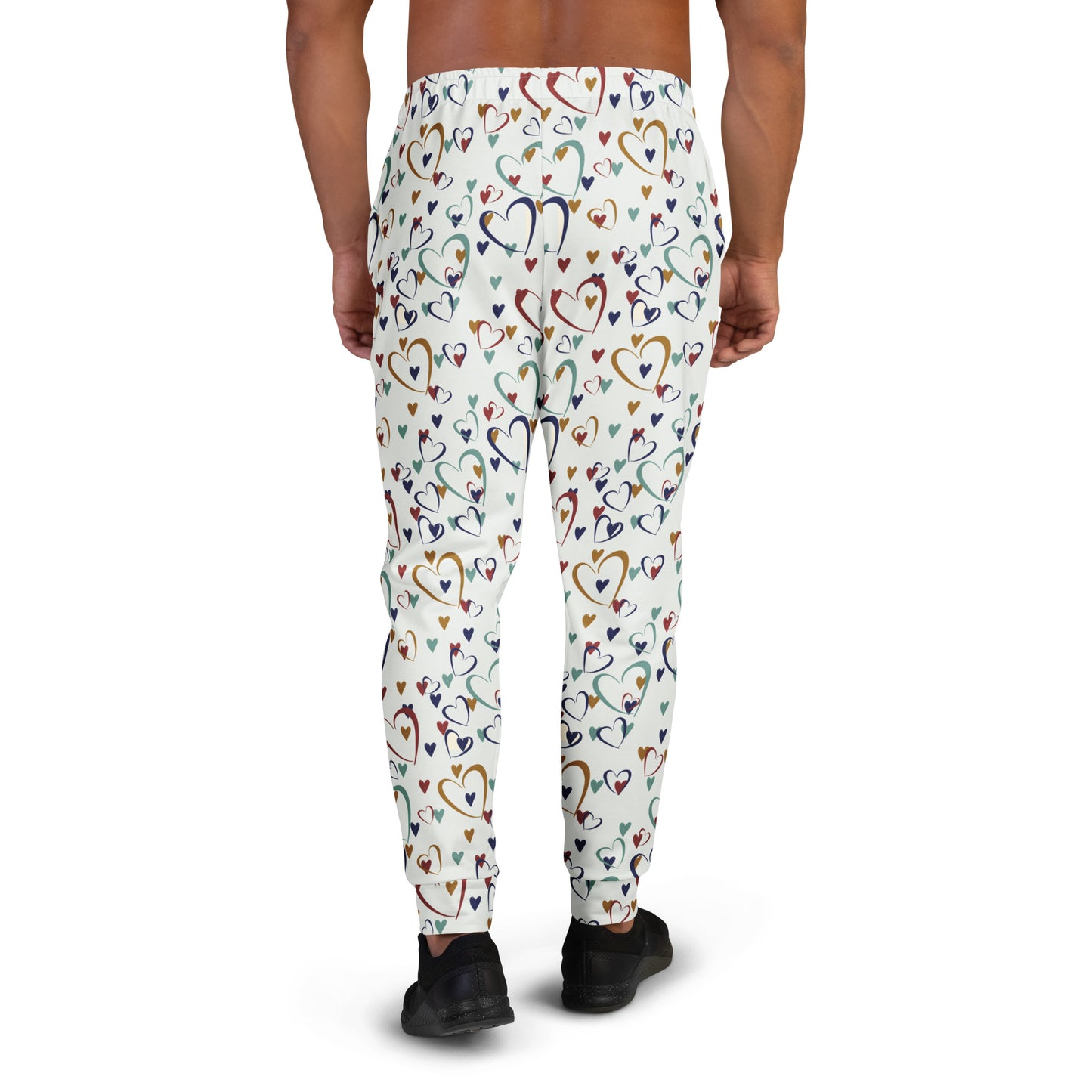 man wearing white leggings with rainbow colored hearts pattern
