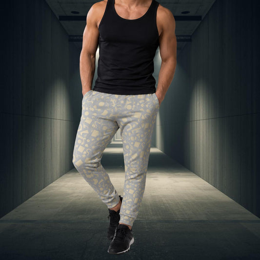 Person wearing a black tank top and light gray patterned jogging pants in a dark hallway.