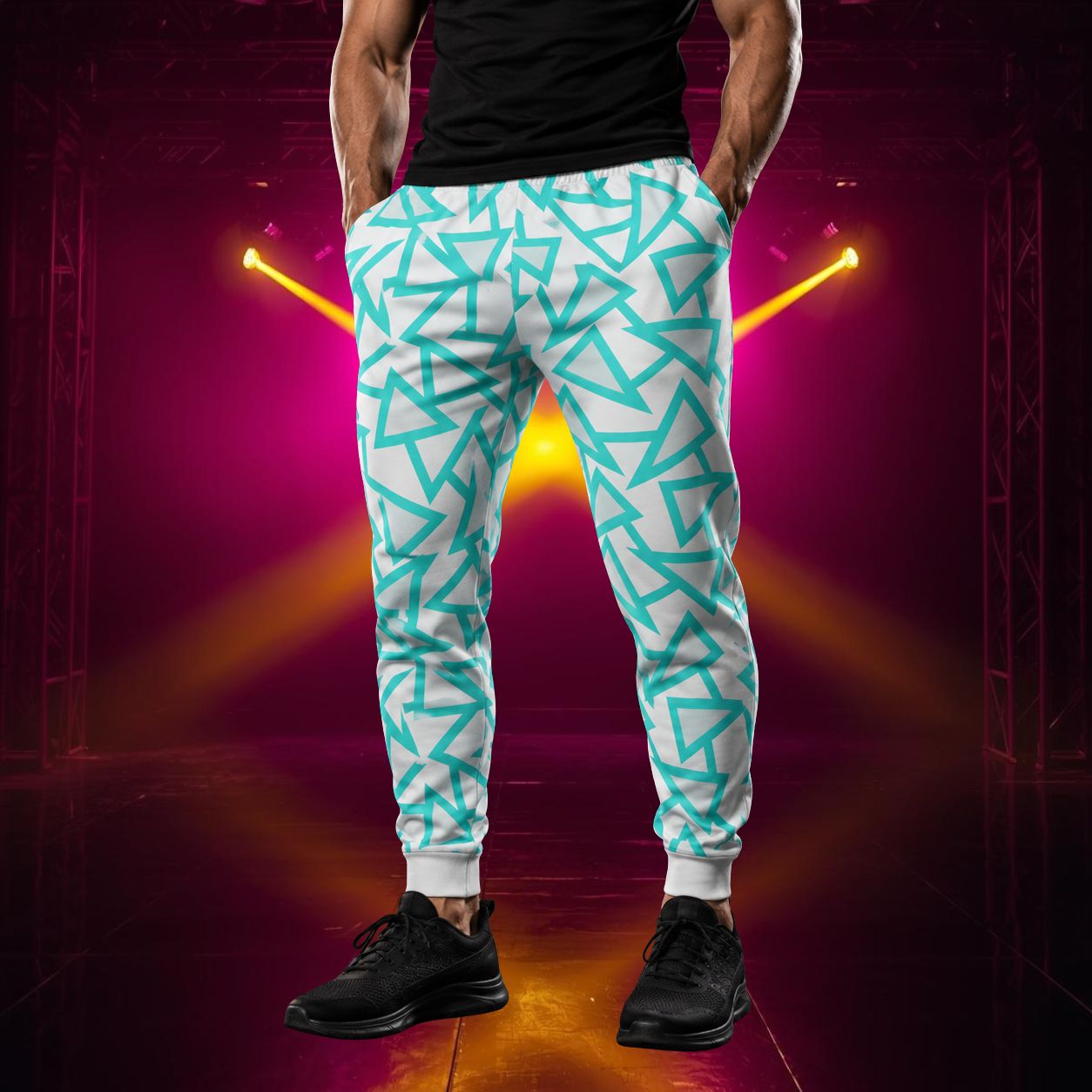 Man wearing jogging pants in a retro blue triangular geometric design in blue against a pale grey background.