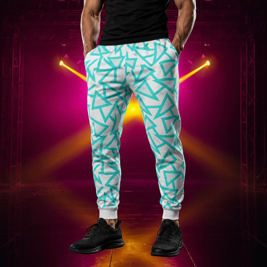Man wearing jogging pants in a retro blue triangular geometric design in blue against a pale grey background.