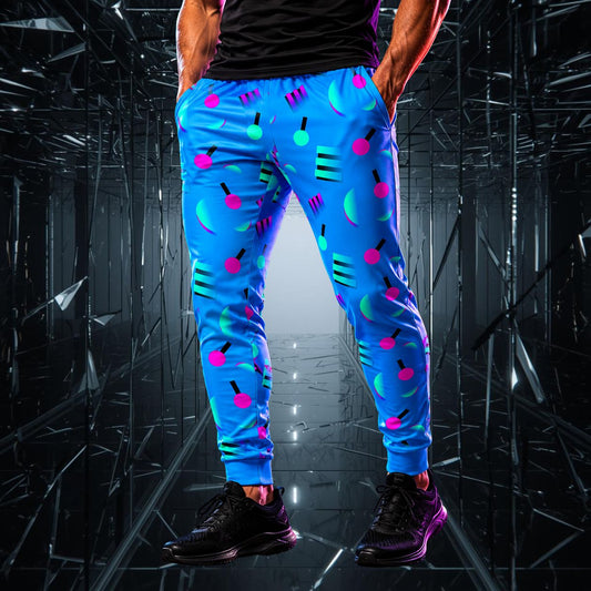 Person wearing blue memphis style jogger pants with colorful geometric patterns in a reflective, dark environment