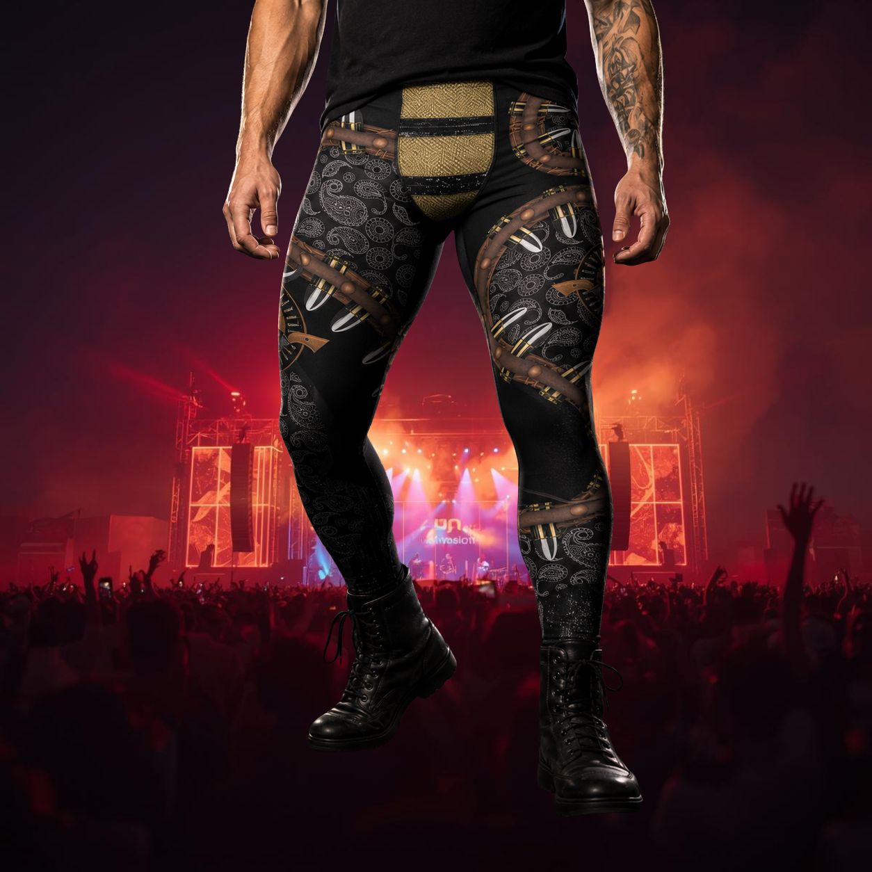 man wearing black leggings with leather bullet belt design, including paisley and gold elements in front of festival at night time