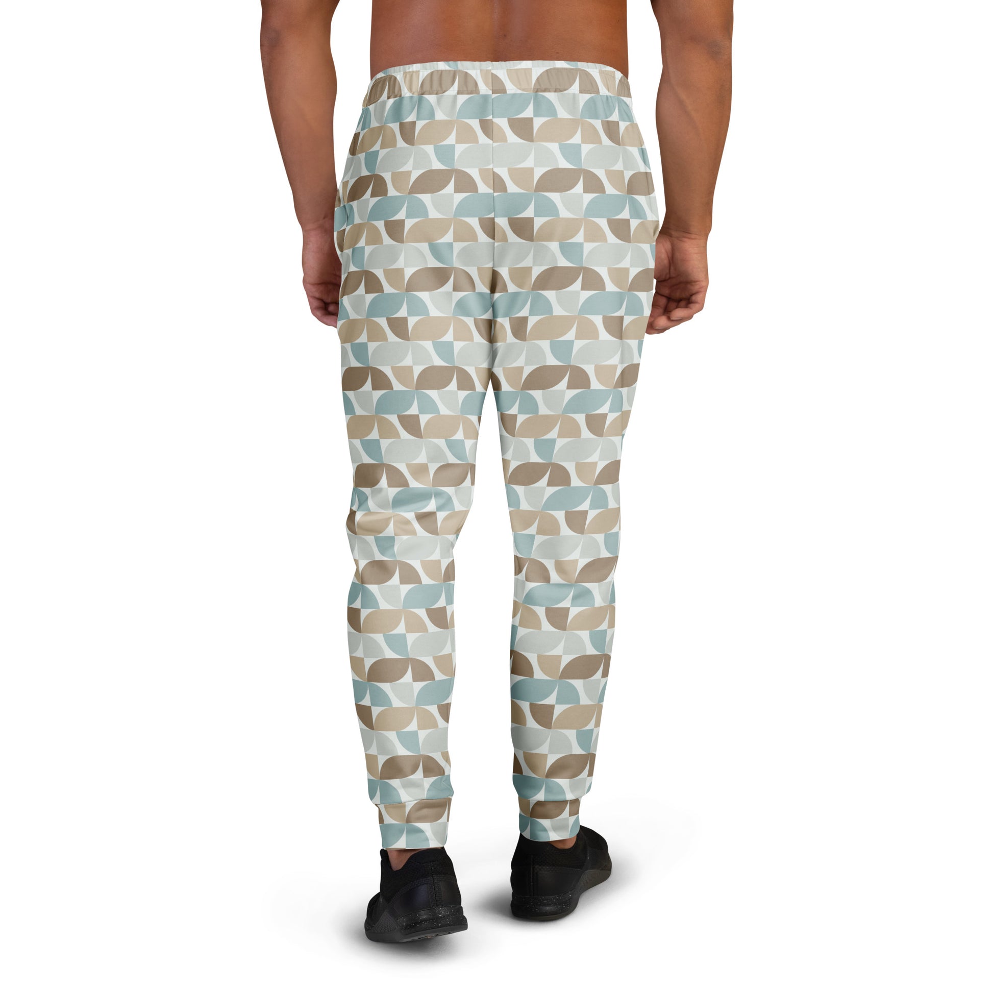 Person wearing  pastel geometric patterned pants on a white background