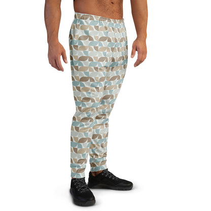 Person wearing  pastel geometric patterned pants on a white background