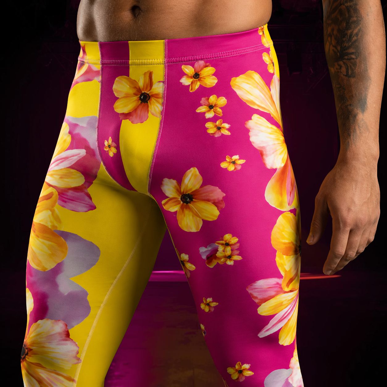 man wearing pink leggings with yellow flowers and alternate yellow leg