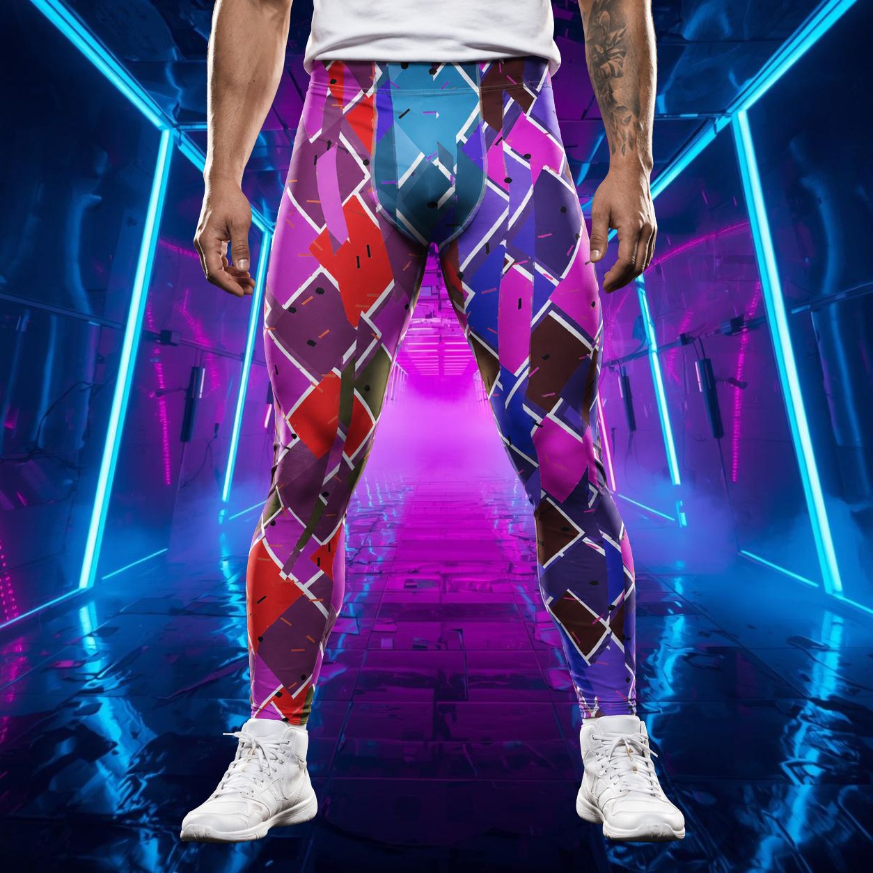 man standing wearing leggings in geometric pattern with fractal design in a wrestling disruption vibe. Broken diamond design in red, pink, blue with broken white outline.