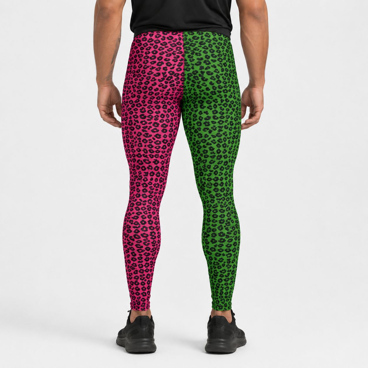 Person wearing pink and green leopard print leggings on a white background