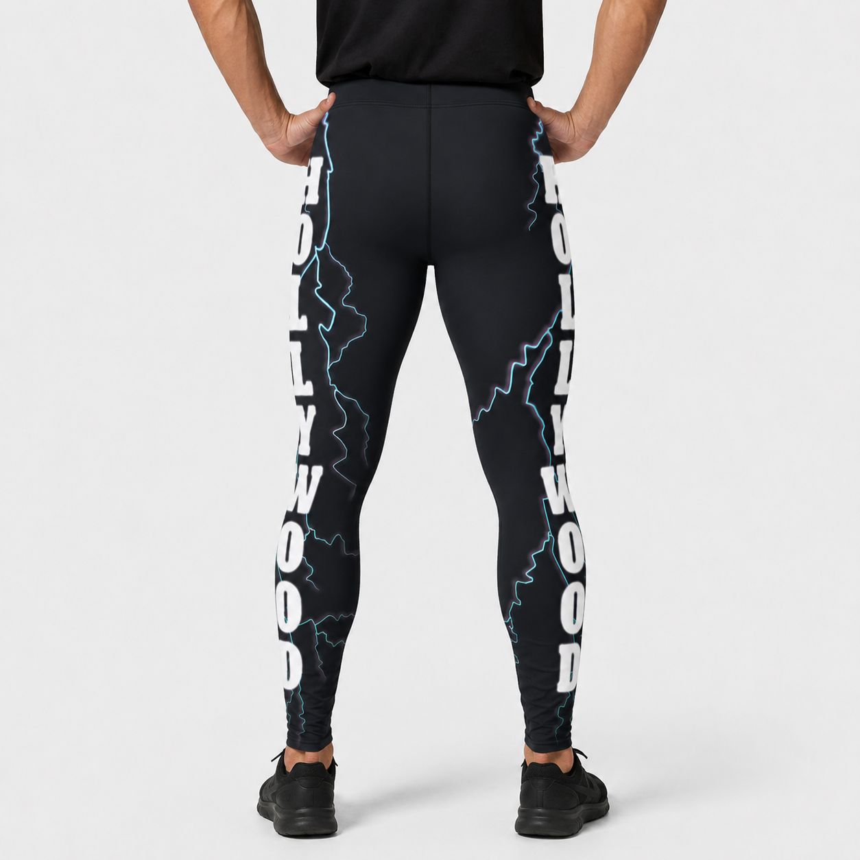 Black leggings with white text and blue lightning designs on a white background