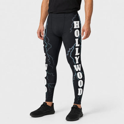 Person wearing black leggings with 'Hollywood' text and lightning designs on a white background
