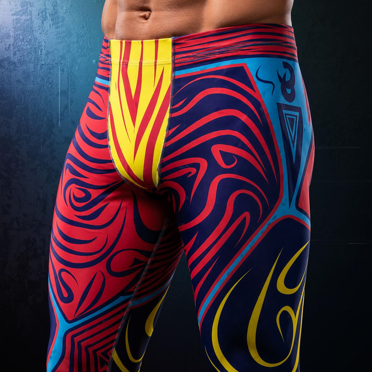 men's leggings in geometric pattern in red, yellow, blue and navy in a luchador style. Closeup.