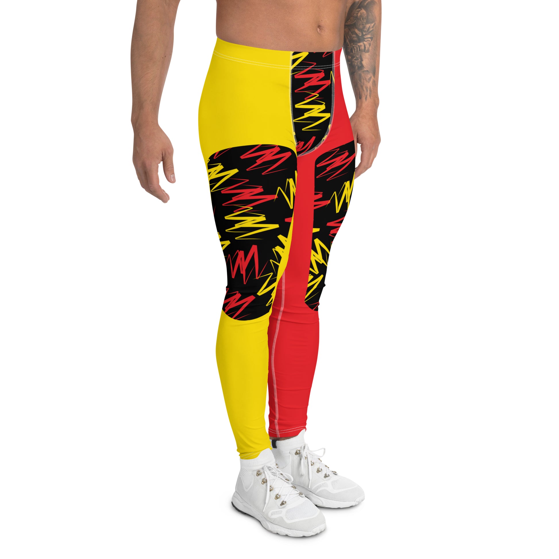 Men's pro wrestling tights in orange and yellow zigzags in alternative insets on each ankle length leg. Mid rise waistband, elasticated. Vibrant fashion meggings, rave outfit, festival gear.