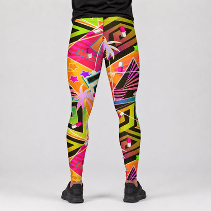 A person shown from the waist down wearing colorful geometric print leggings with palm trees, stars, and lipstick motifs, paired with black sneakers against a light gray studio background.